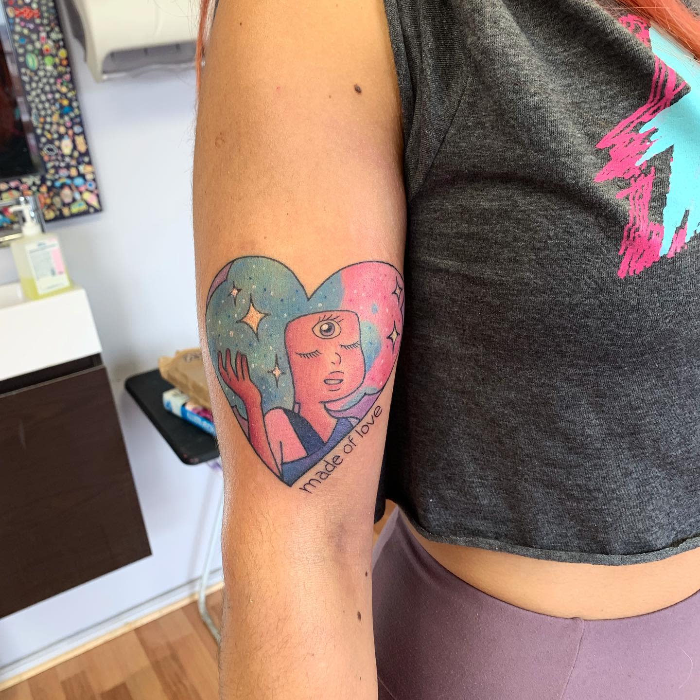 Colorful tattoo of Garnet from Steven Universe inside a heart shape with a cosmic background, featuring the text 'made of love