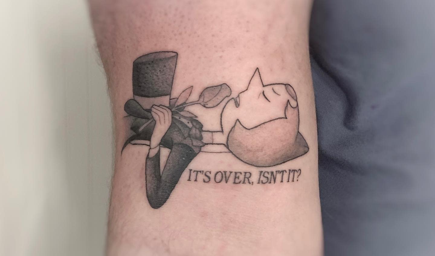 A beautifully detailed tattoo of Pearl from Steven Universe, depicting her holding a rose with the iconic line 'It's over, isn't it?'