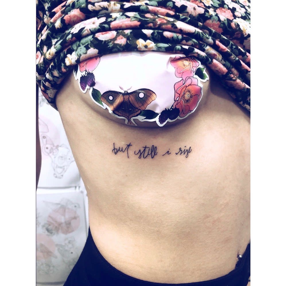 Lower side tattoo of "but still, i rise" 