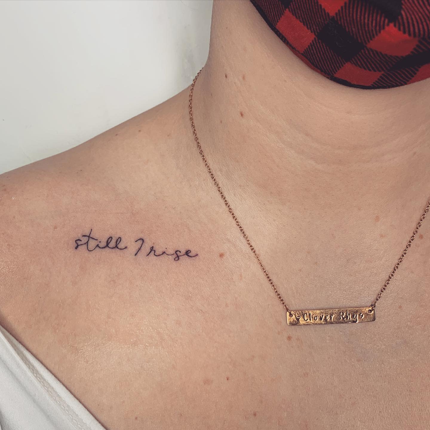 A "still I rise" tattoo on a shoulder