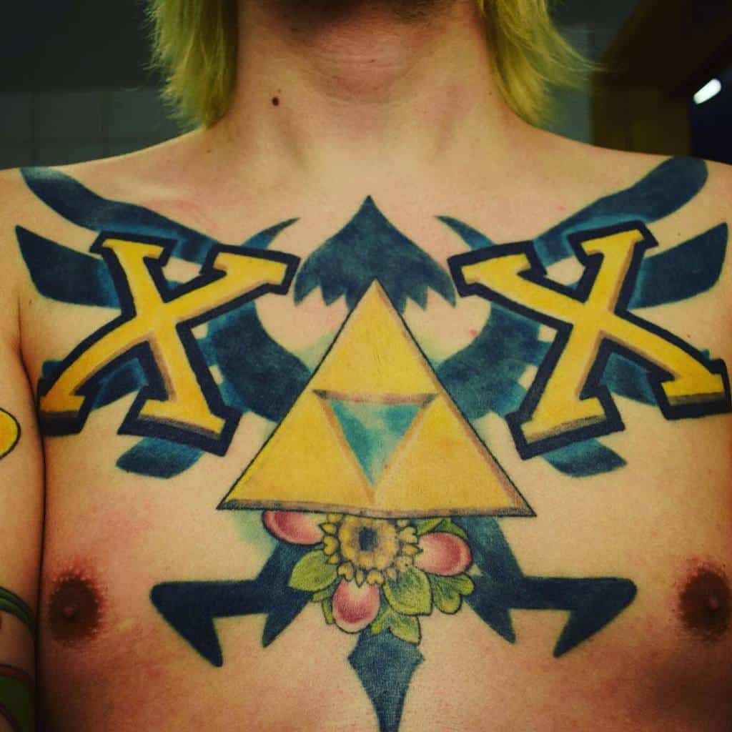 Bold tattoo featuring large yellow 'X' symbols, a Triforce emblem, and a floral design, blending straight edge and Legend of Zelda symbolism