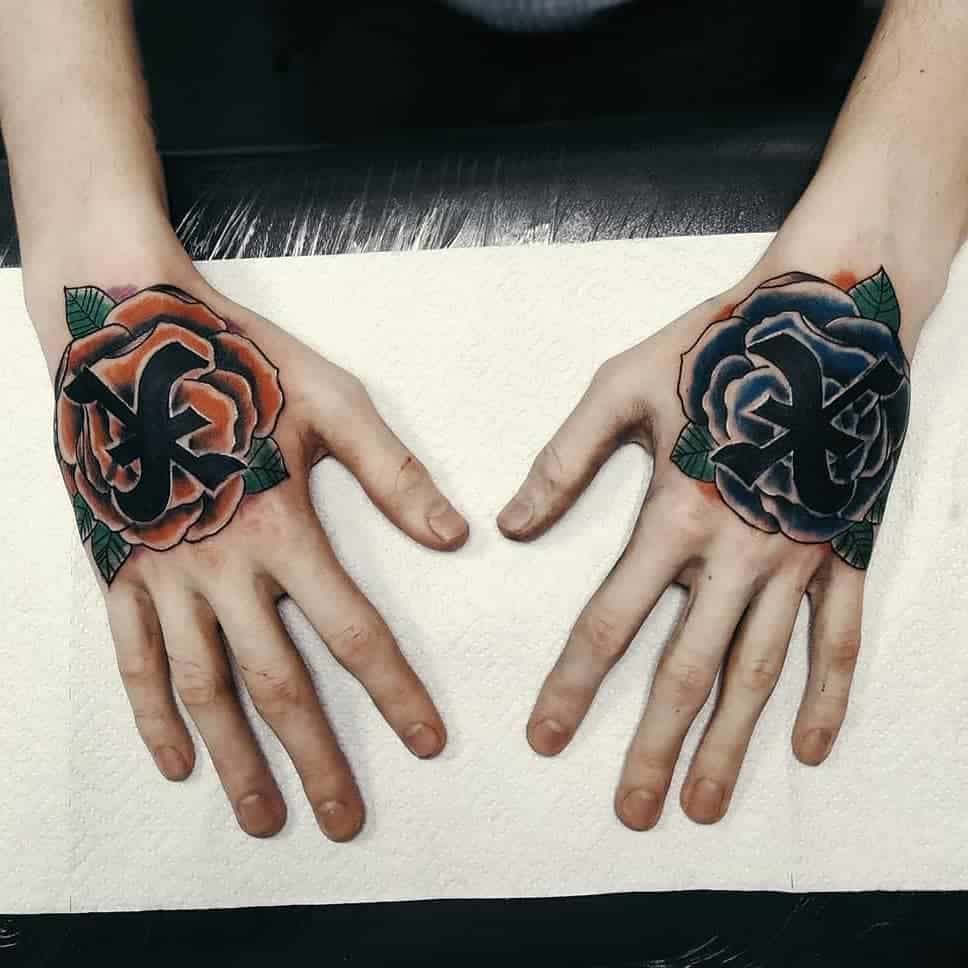 Bold hand tattoos featuring a red and a blue rose, each with a black straight edge 'X' in the center