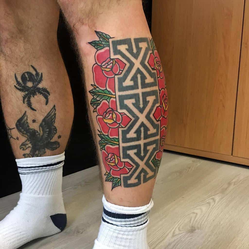 Straight edge tattoo with three bold 'X' symbols in a geometric pattern, framed by vibrant red roses and green leaves for contrast