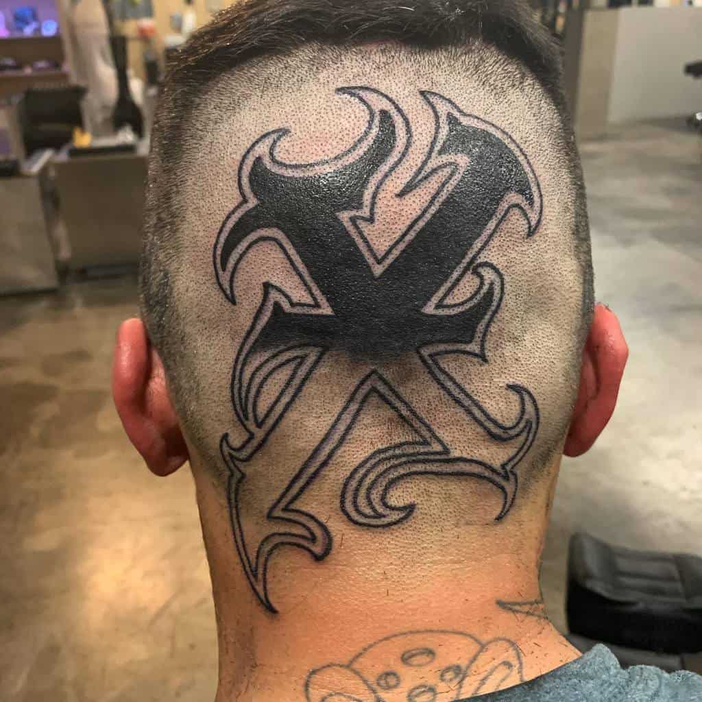 Bold straight edge head tattoo featuring a large black 'X' with intricate tribal-style outlines