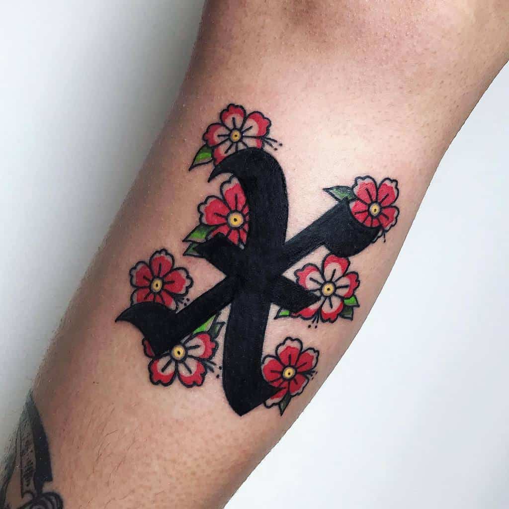 Straight edge tattoo featuring a bold black 'X' surrounded by vibrant red flowers with green leaves