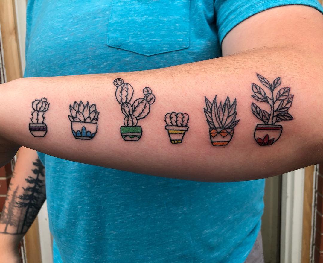 Forearm showing tattoos of six potted succulents, each in a different colored pot