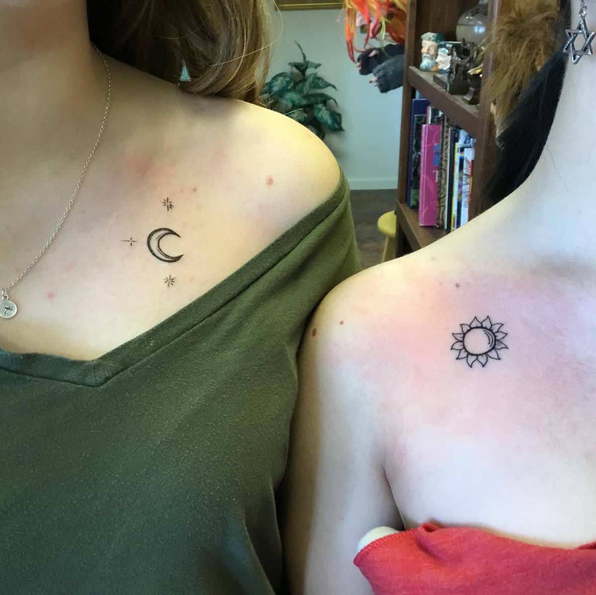 Moon and stars tattoo on left shoulder, sun tattoo on right shoulder