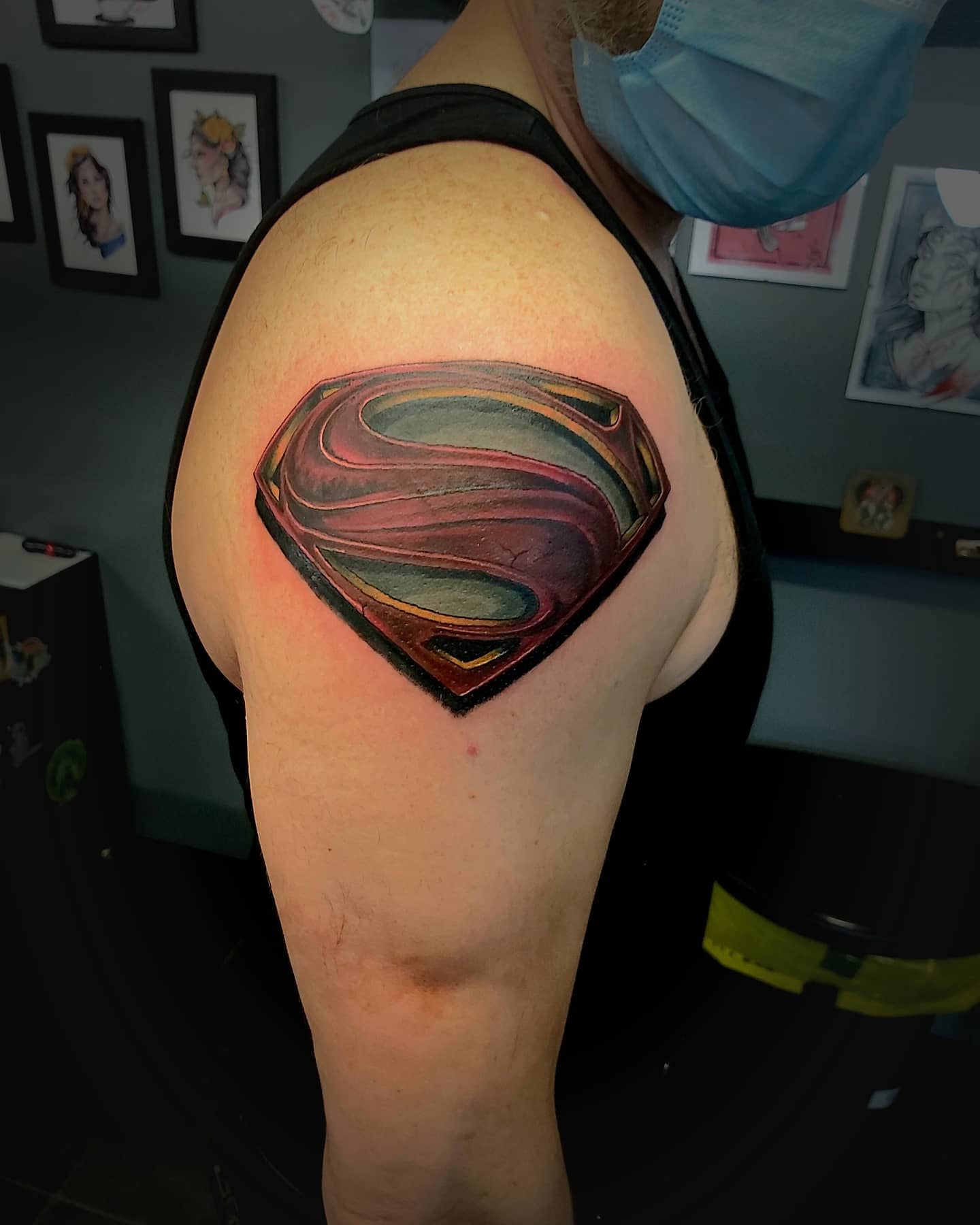 Upper arm with a Superman logo tattoo