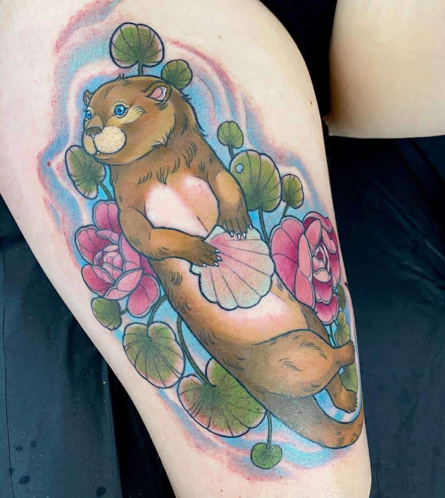 Vivid otter tattoo cradling a shell, set amid lush pink flowers and vibrant green leaves