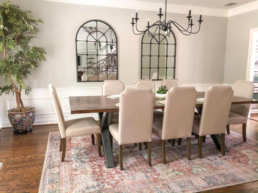 candle chandelier long dining room table and chairs window mirrors floor rug