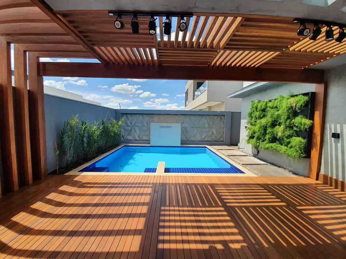 luxury tan deck in-ground swimming pool wall plants