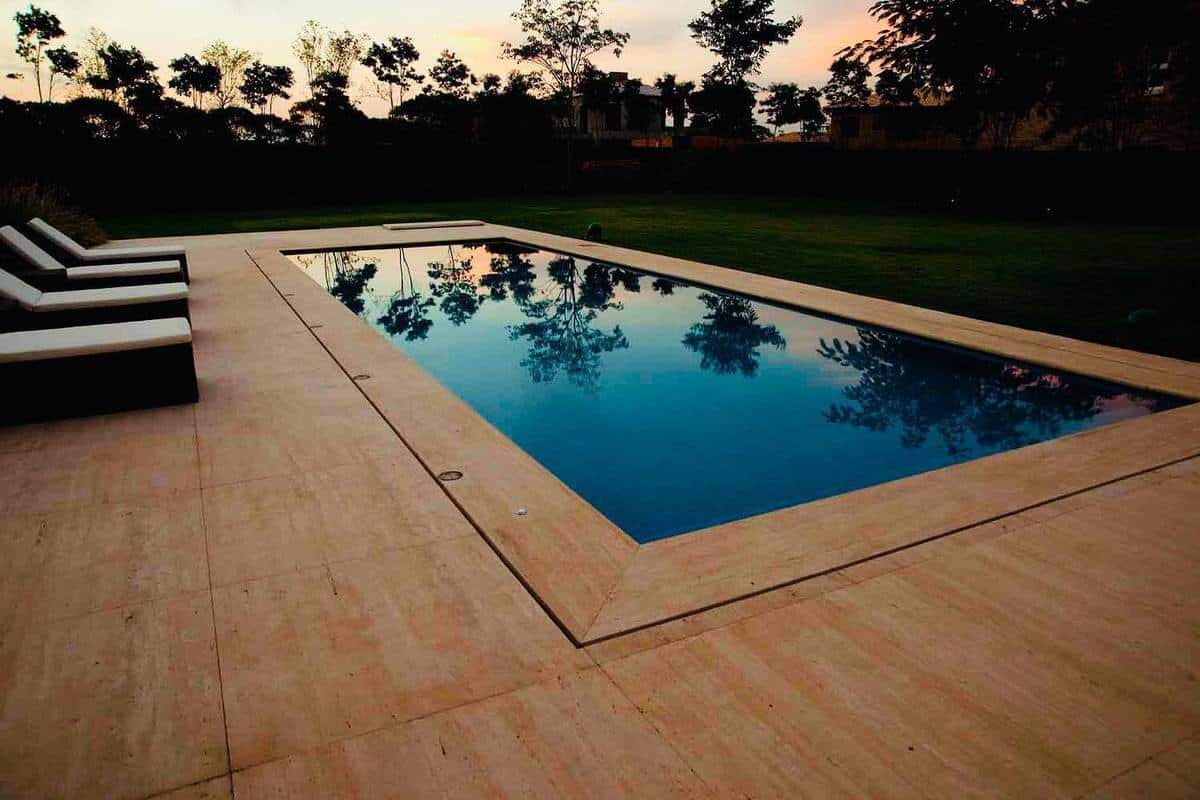 tan deck in-ground swimming pool