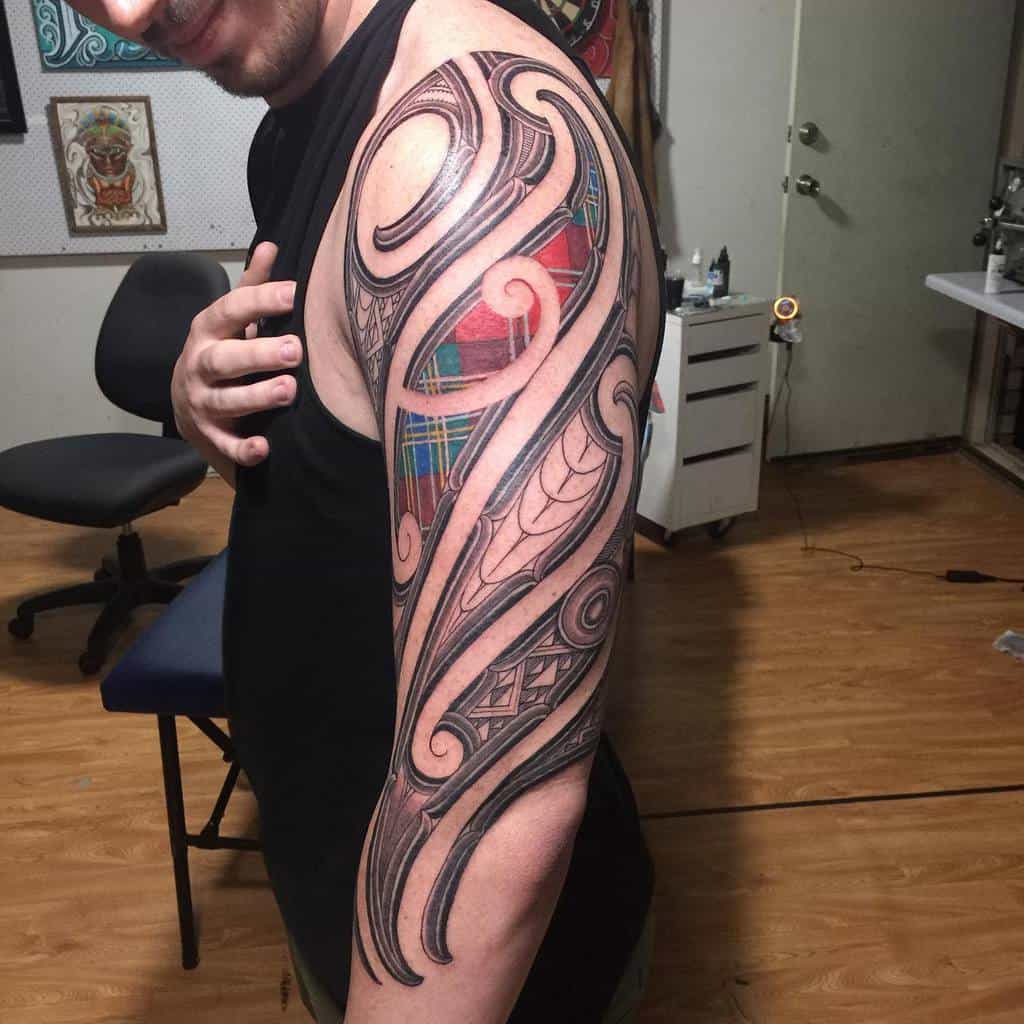 An intricate Scottish tribal tattoo featuring swirling patterns and colored sections