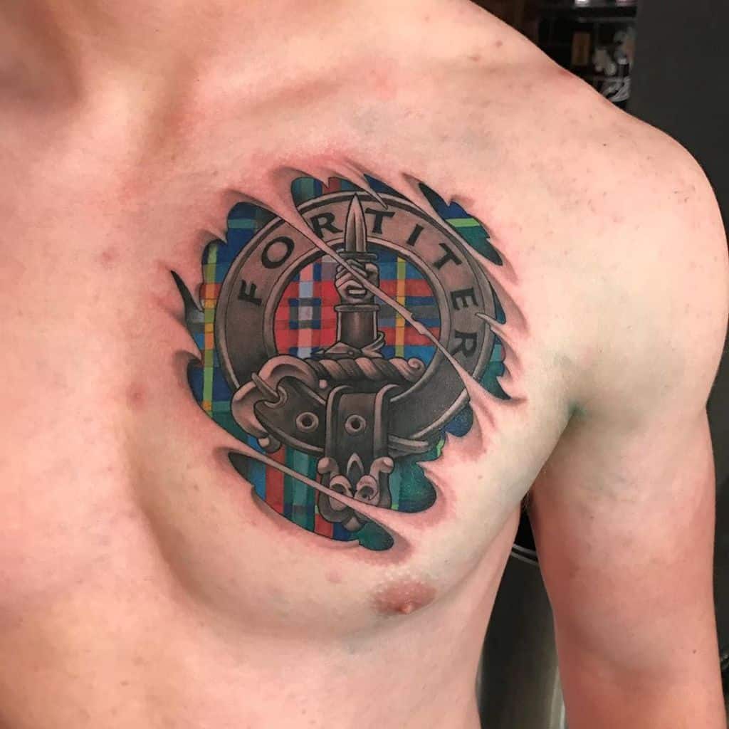 Colorful Scottish crest tattoo on shoulder featuring a knight's helmet and sword, framed by a tartan pattern and the motto 'Fortiter'