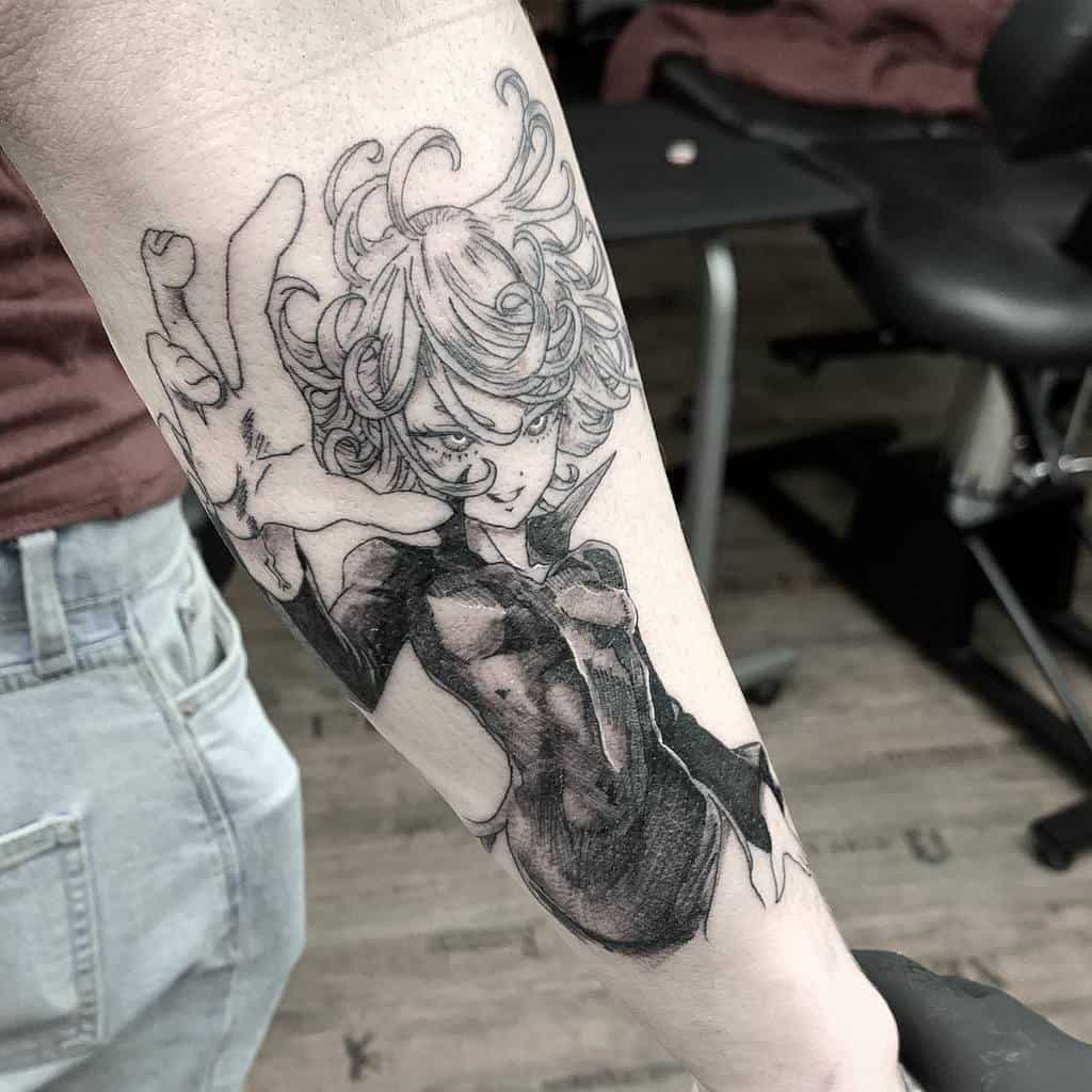 Black and grey tattoo of Tatsumaki from One Punch Man on the forearm, showcasing her intense expression, flowing hair, and dynamic pose