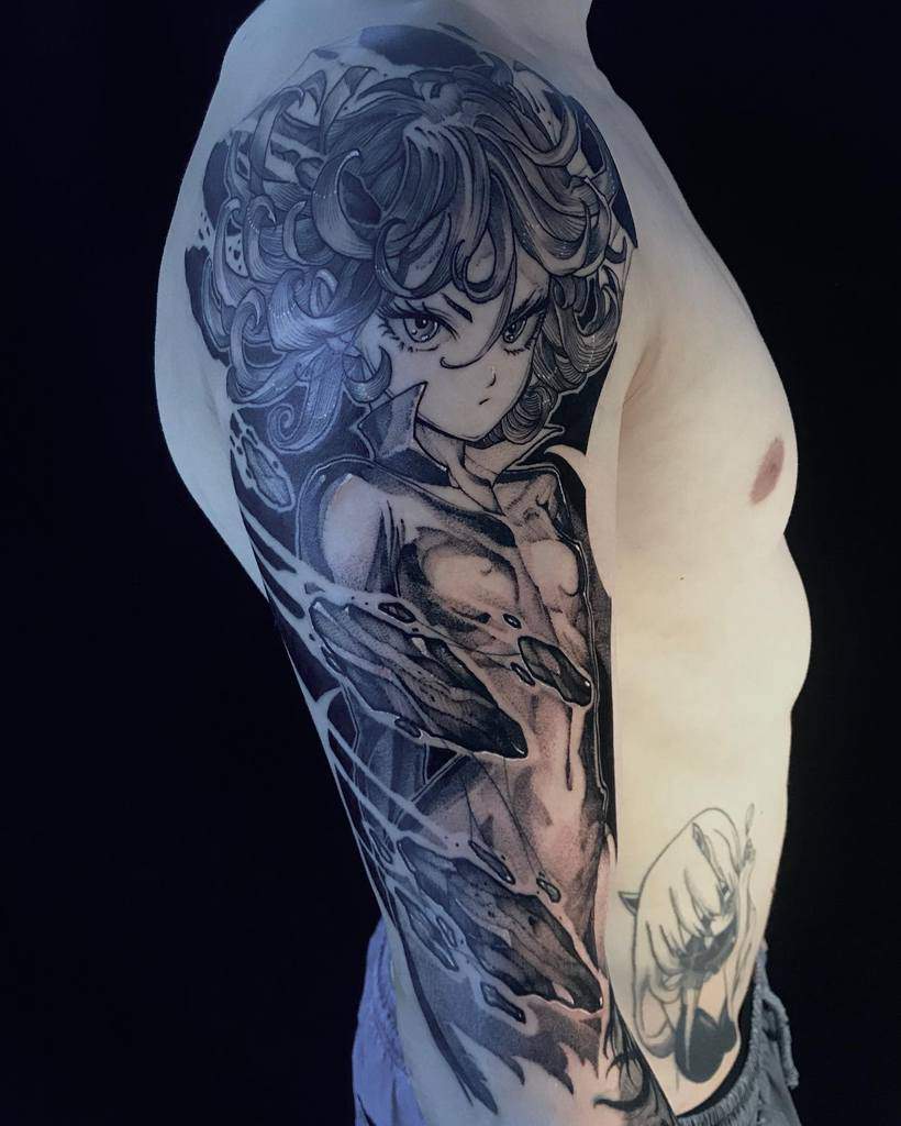 Detailed black and grey sleeve tattoo of Tatsumaki from One Punch Man, featuring intense shading, swirling energy, and a powerful pose