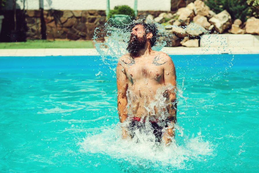 Tattooed And Bearded Man In Pool