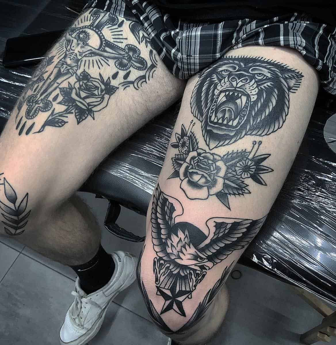 Roaring bear and eagle tattoos with intricate designs on thighs