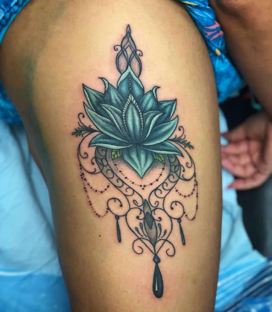  Chandelier-style tattoo with a teal lotus flower, intricate ornamental details, beaded chains, and teardrop-shaped crystal accents
