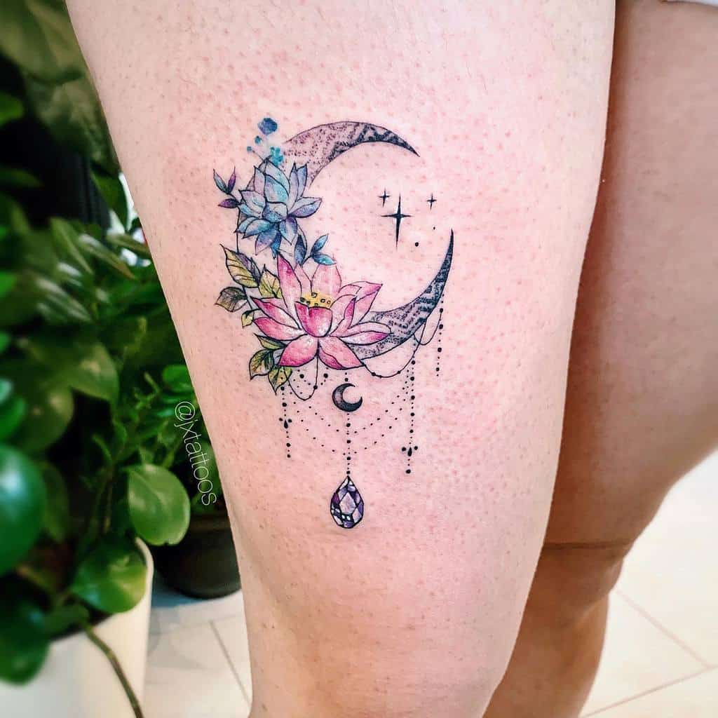 Chandelier-style crescent moon tattoo with pink and blue flowers with leaves, delicate beaded chains, a small crescent moon charm, a teardrop crystal, and stars