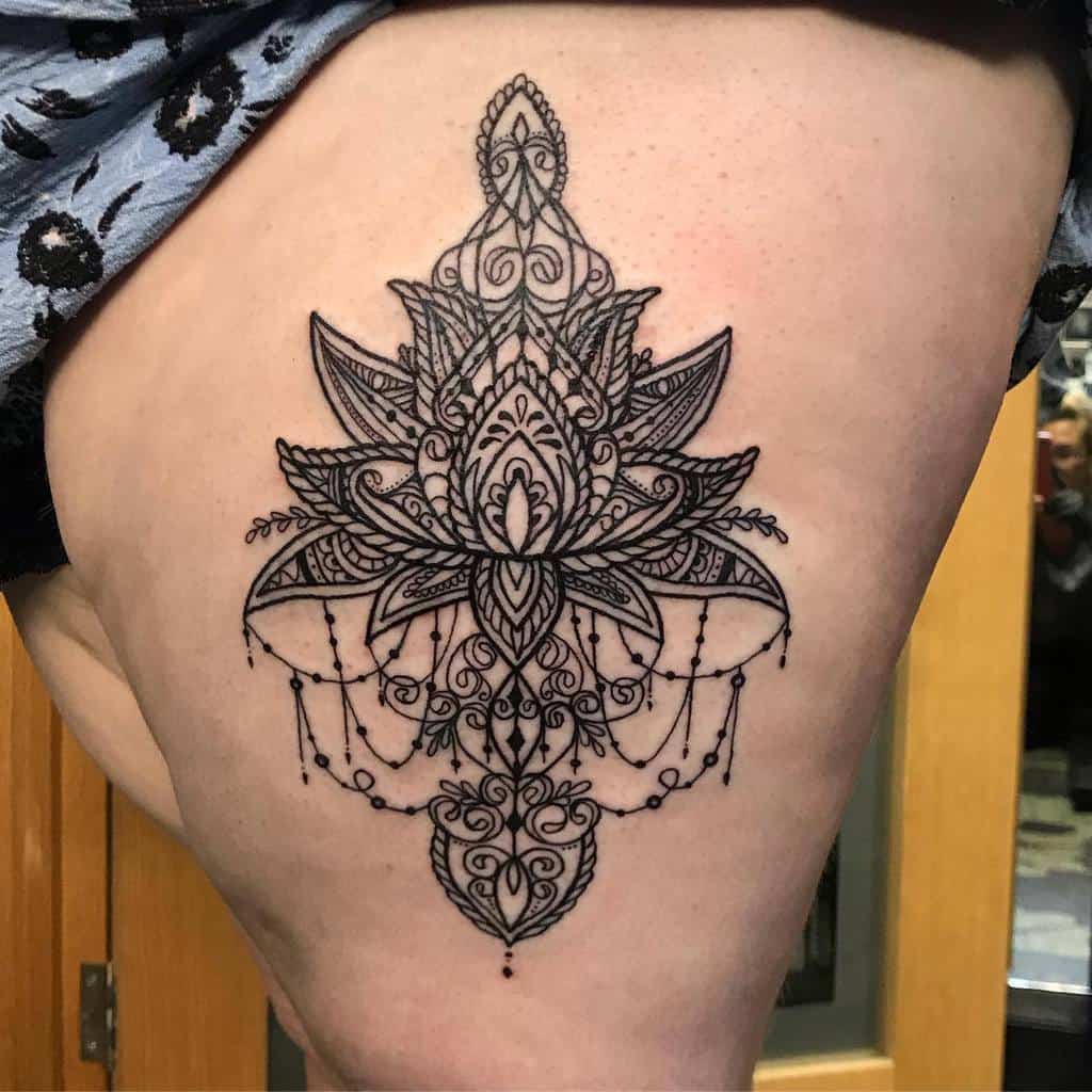 Intricate chandelier-style tattoo featuring a symmetrical lotus flower, ornate mandala patterns, delicate beaded chains, and elegant linework