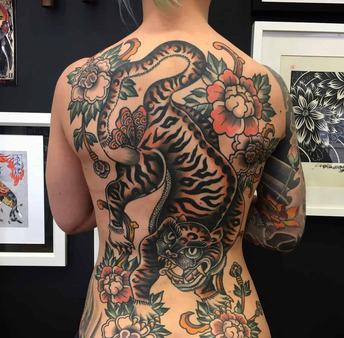 Full-back tattoo of a tiger surrounded by flowers and traditional Korean designs