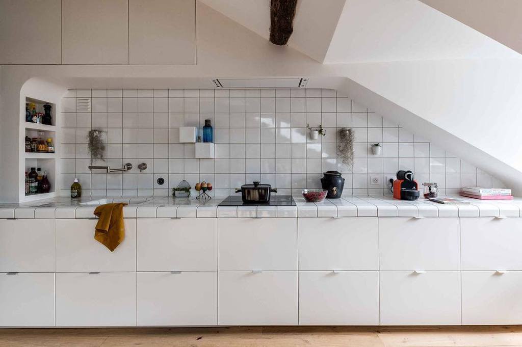 long white cabinet kitchen with tile bench top and backsplash
