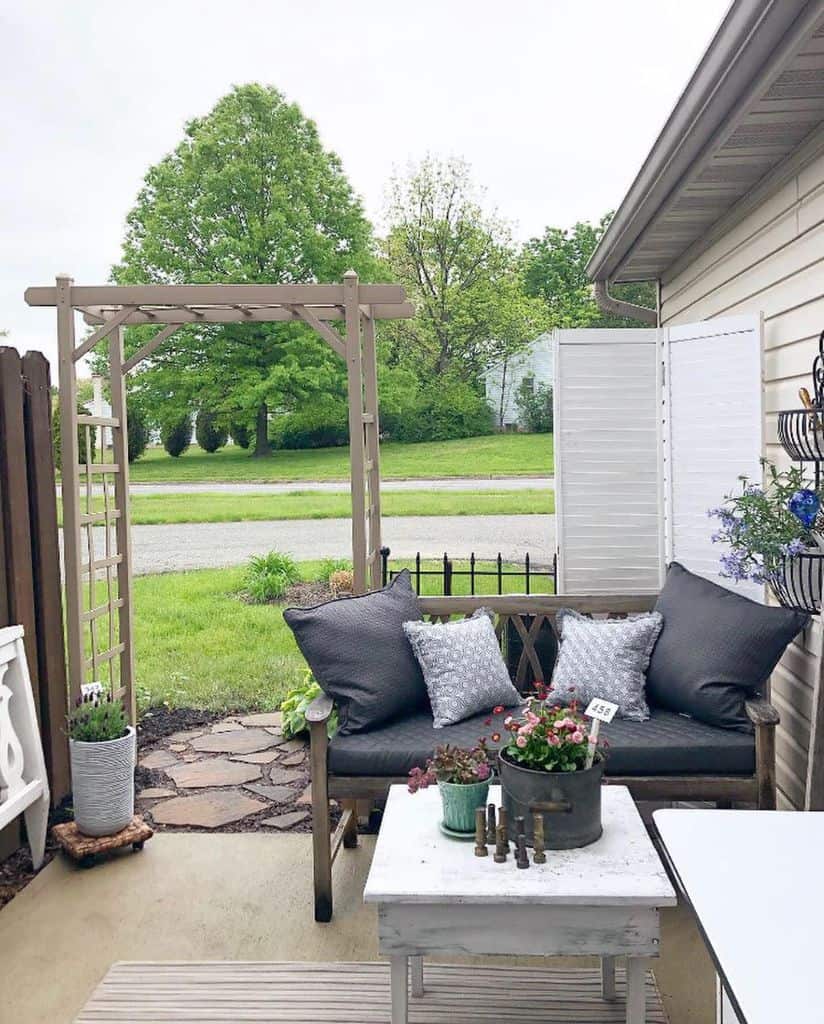 small patio with wood bench and stone table 