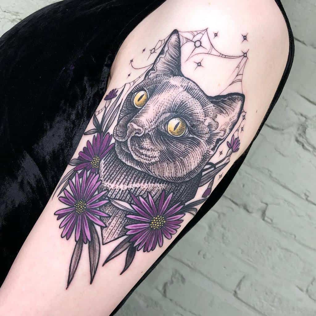 Tattoo of a cat with yellow eyes surrounded by purple asters