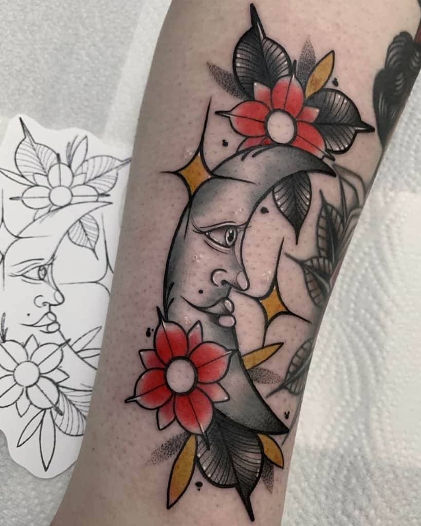 Tattoo of a mysterious crescent moon with eyes surrounded by vibrant red flowers and sleek black leaves
