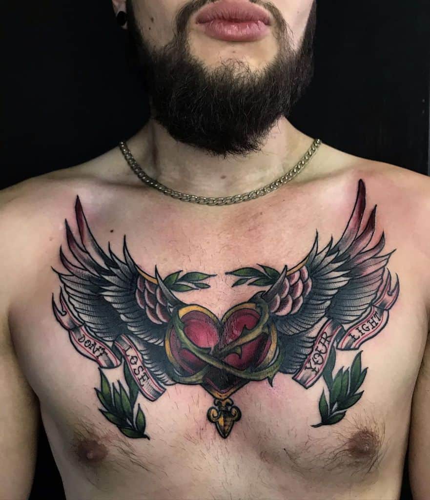 A man with a chest tattoo of a heart intertwined with wings, and a banner reading "Don't Lose Your Fight"