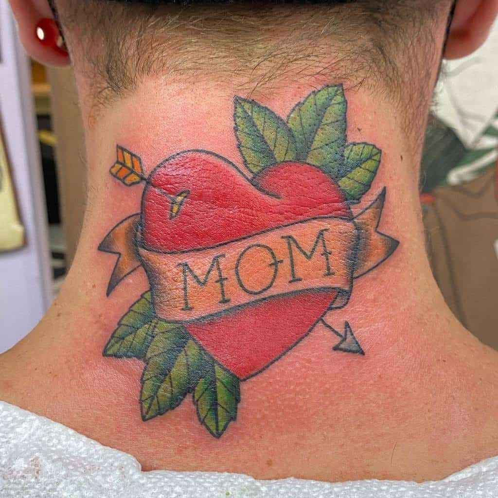 Tattoo of a heart with the word "Mom" and arrows, adorned with leaves