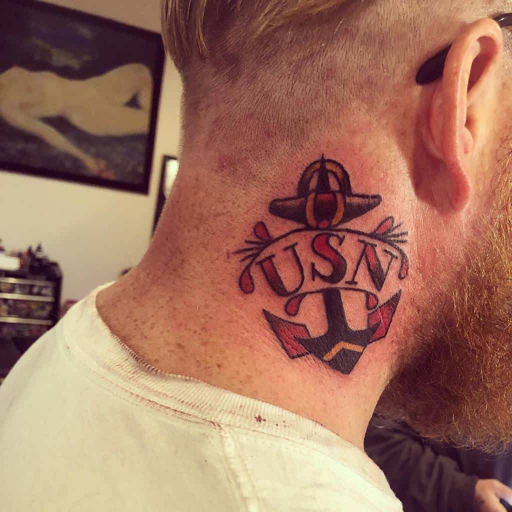 Tattoo of an anchor and "USN" on the man's neck, symbolizing his deep connection to the navy
