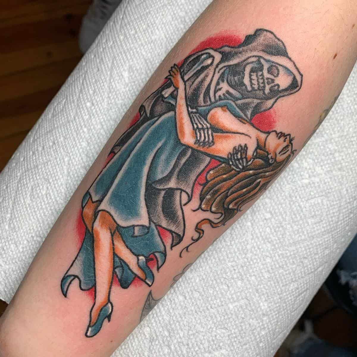 Tattoo of a skeleton in a cloak and a woman in a blue dress dancing on forearm