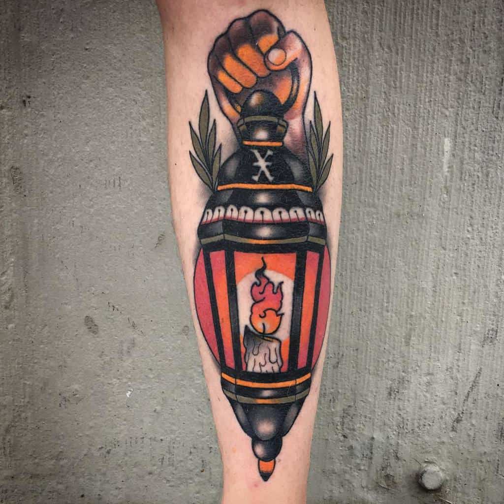 Straight edge tattoo of a hand holding a lantern with a burning candle inside, adorned with leaves on either side and "X" as symbol