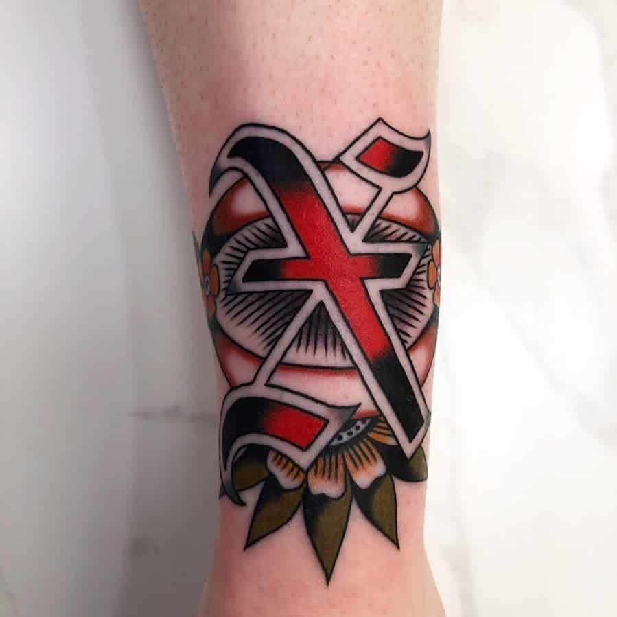 Straight edge tattoo of a large red and black letter 'X' with floral and geometric designs