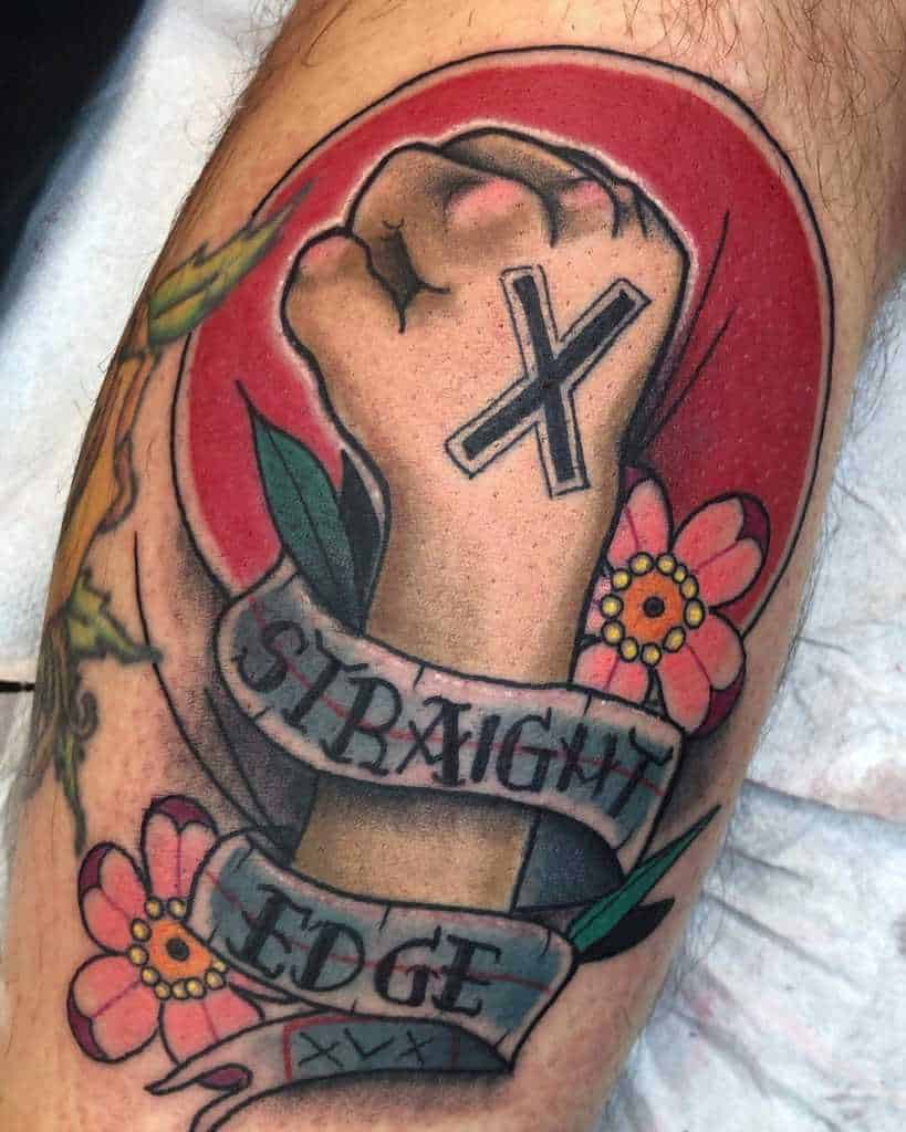 Colorful tattoo of a fist with an "X" on it, surrounded by flowers and a banner reading "Straight Edge"