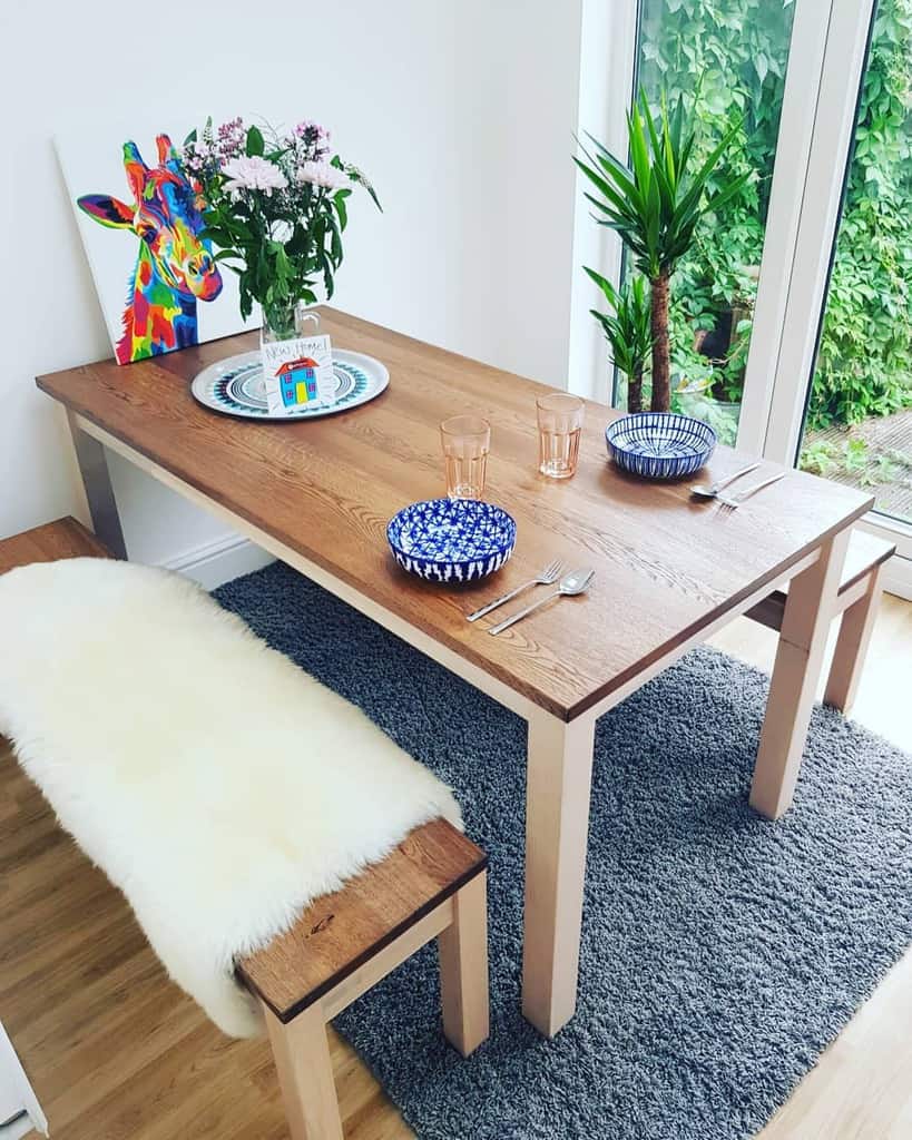 wood table and bench seating in sunroom