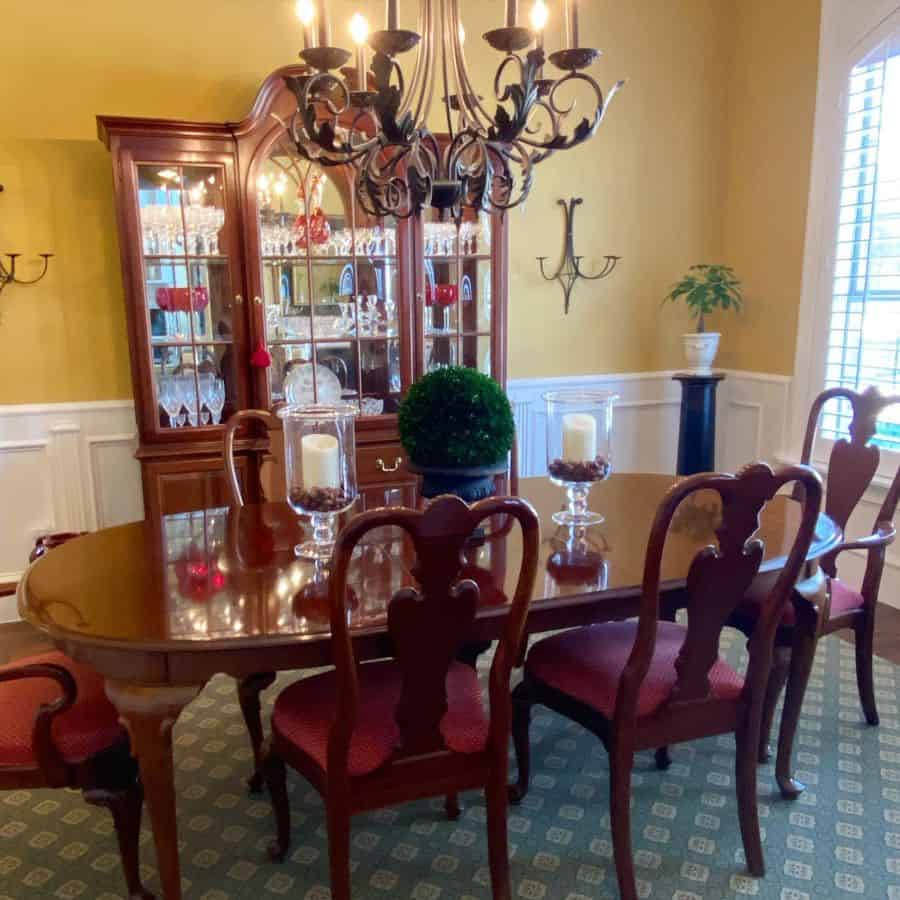 wood dining table and chairs glassware cabinet chandelier