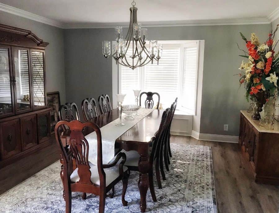 long dining table and chairs pattern floor rug chandelier flowers