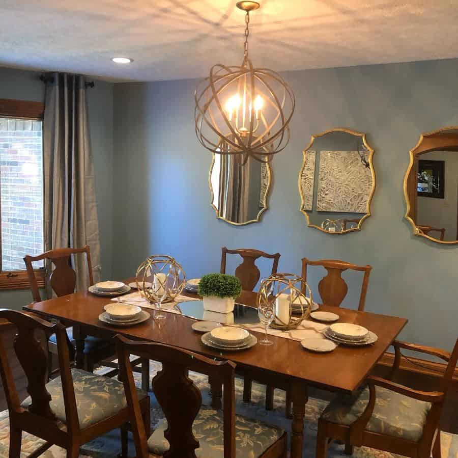 unique chandelier wall mirrors brown table and chairs 