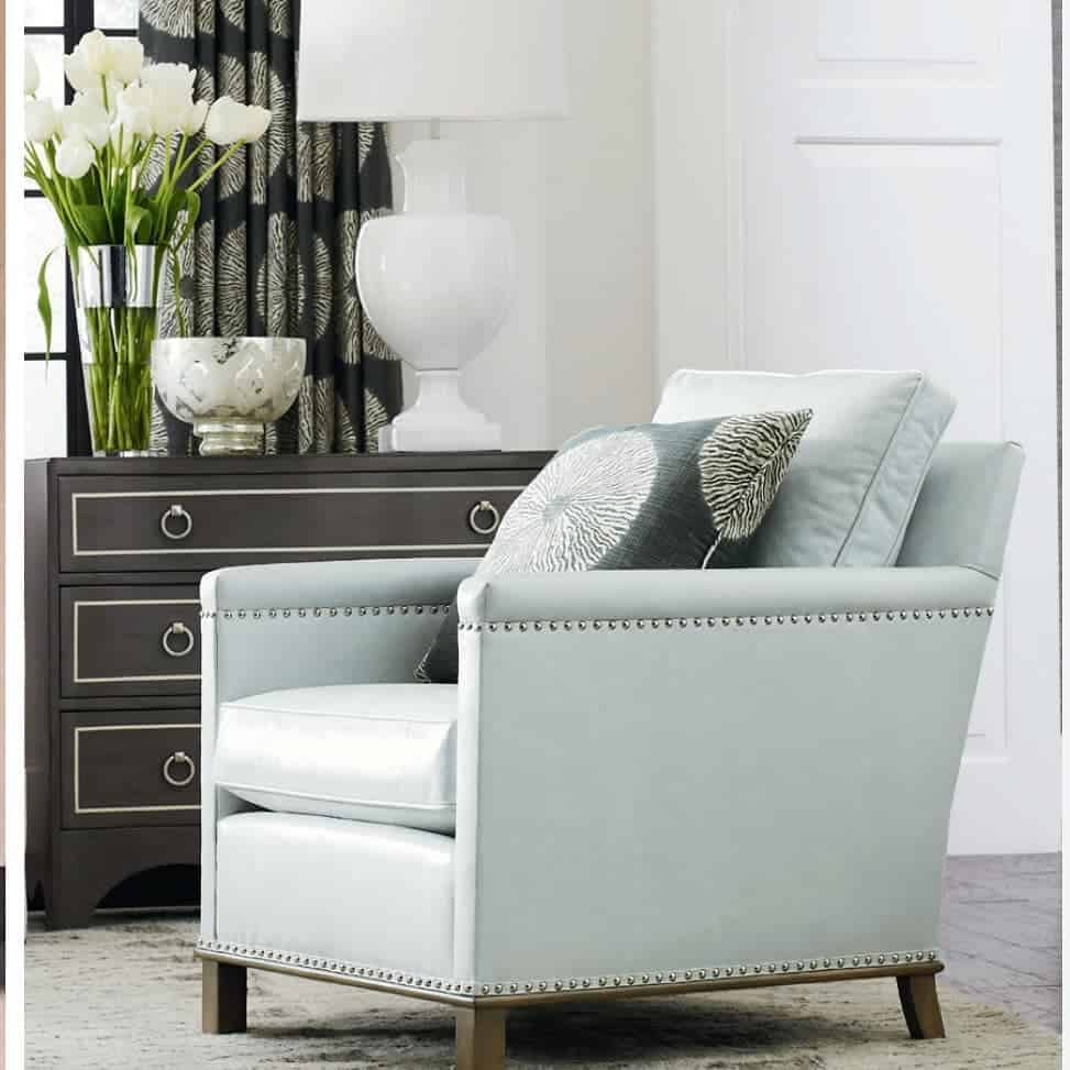 blue accent chair and gray cabinet in small room