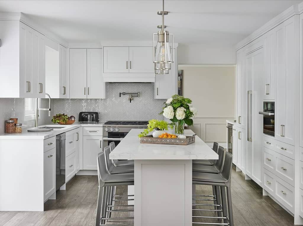 white cabinet kitchen with island and gray seats