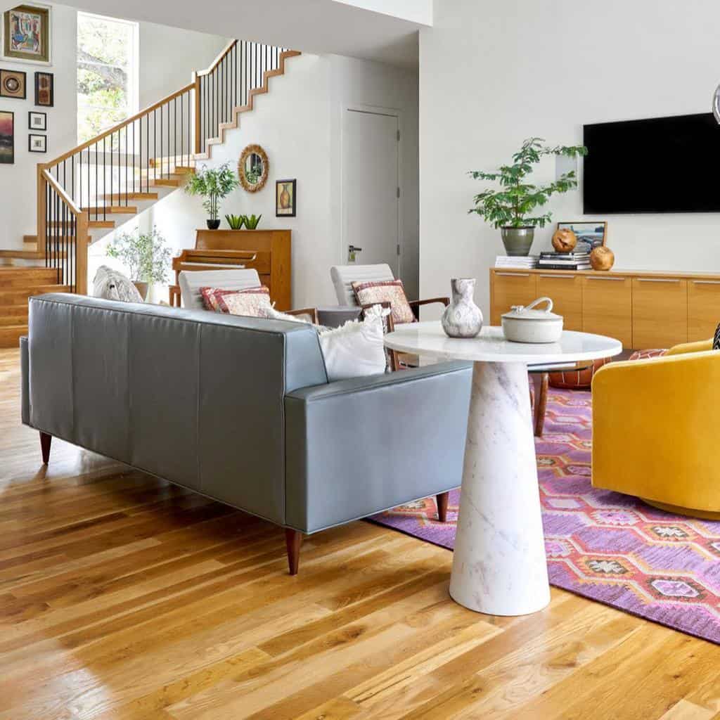 downstairs living room with yellow accent chair and white table