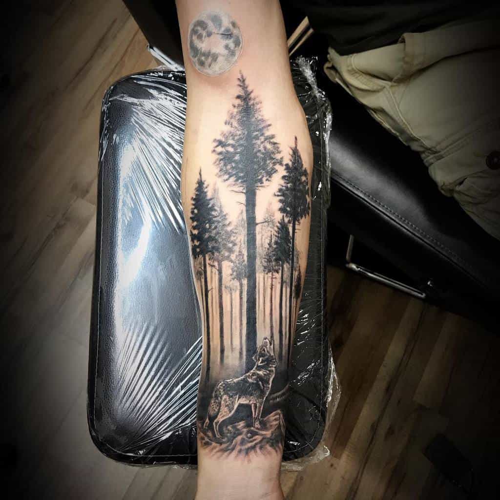 Wolf howling at the moon tattoo on a forearm, surrounded by tall pine trees