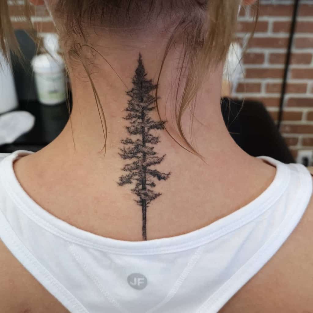 Detailed tree silhouette tattoo on the back of the neck