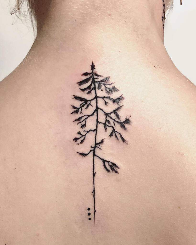 Tattoo of a detailed pine tree silhouette with three dots vertically aligned below it on an upper back