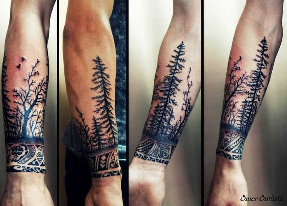 Forearm tattoo with detailed tree silhouettes and tribal wristband design, symbolizing nature, strength, and cultural heritage