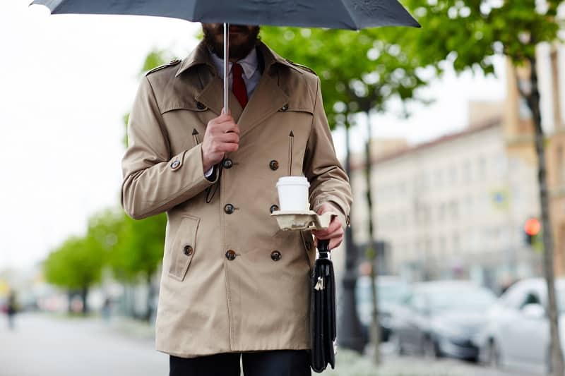 Businessman,Under,Umbrella,Carrying,Drink,And,Briefcase
