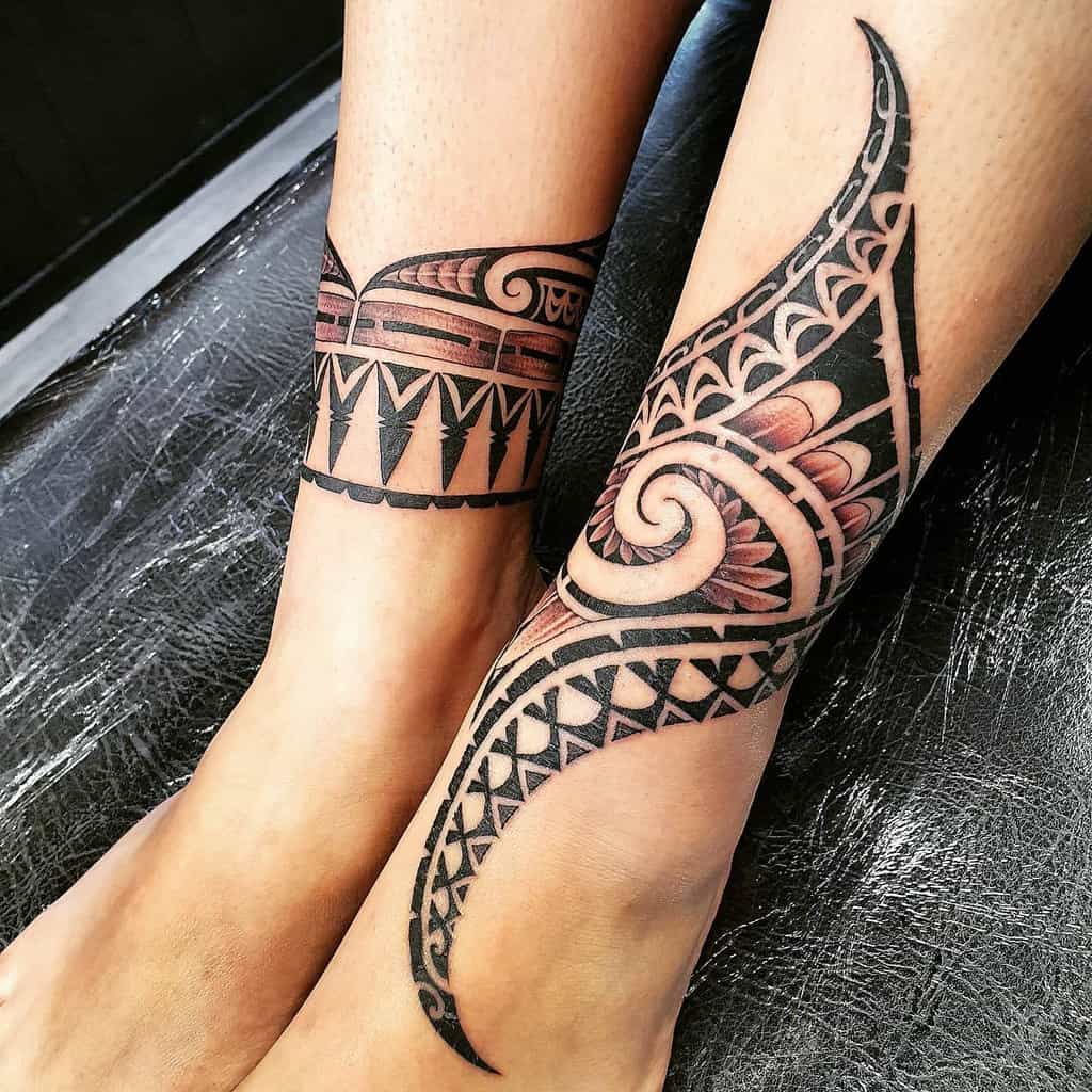 Polynesian tattoos on legs show intricate black patterns with curves and triangles